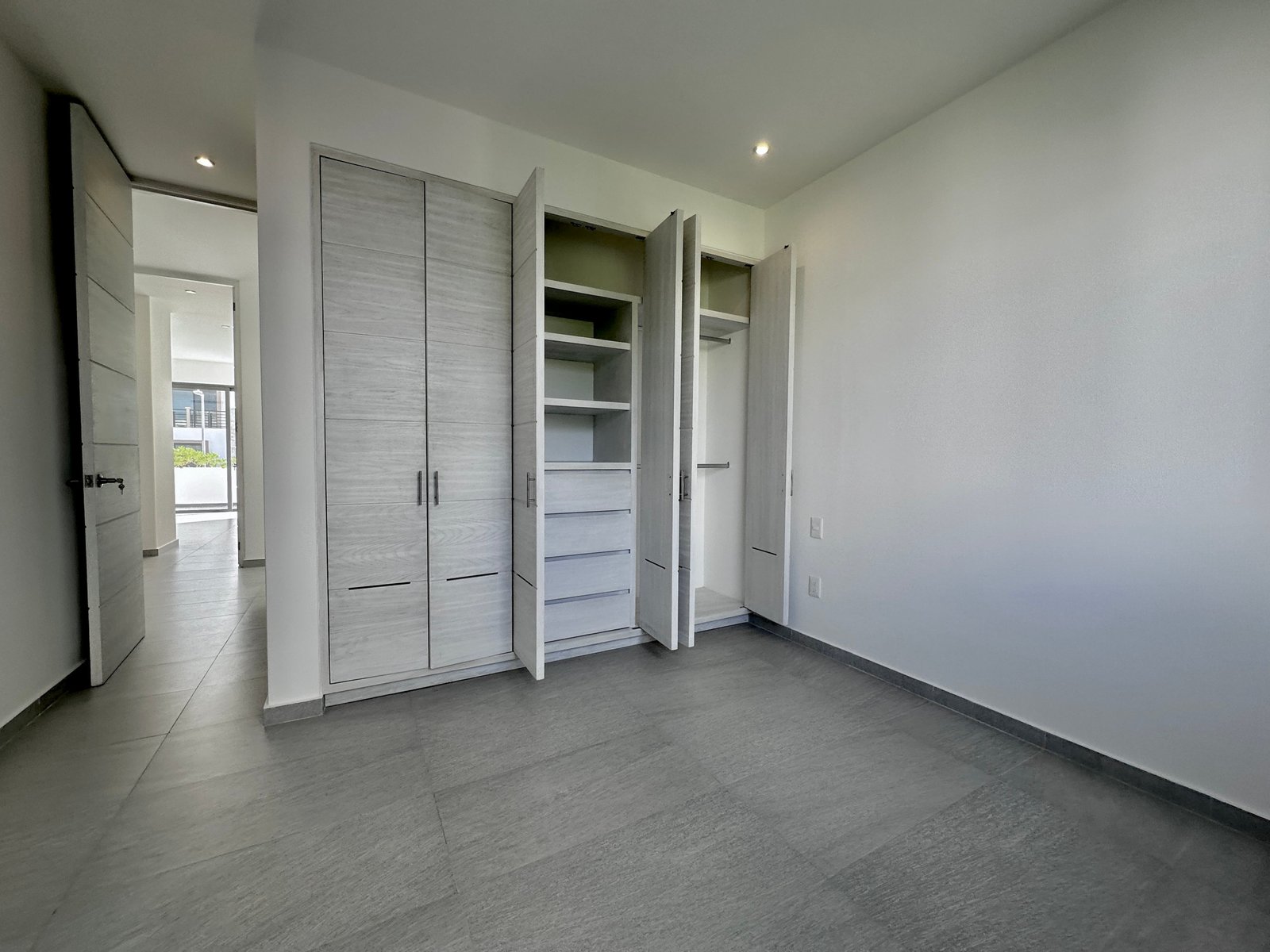 House for sale on Huayacan Ave – built-in closet in light wood, lit by natural light