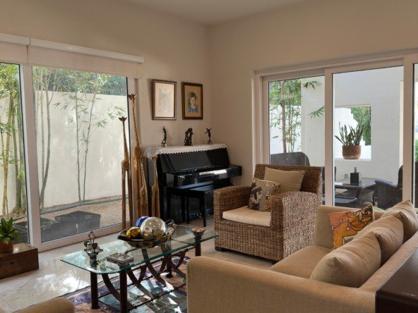 Casa en venta en lagos del sol cancun - Sala de estar con vista al jardín trasero y pasillo lateral