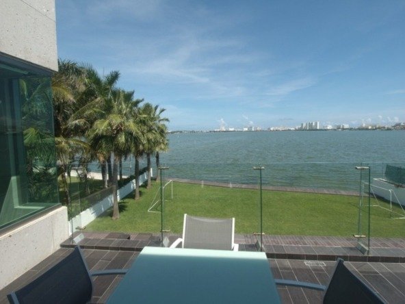 House for sale Isla Dorada Cancun – balcony view toward lagoon with hotels in the background